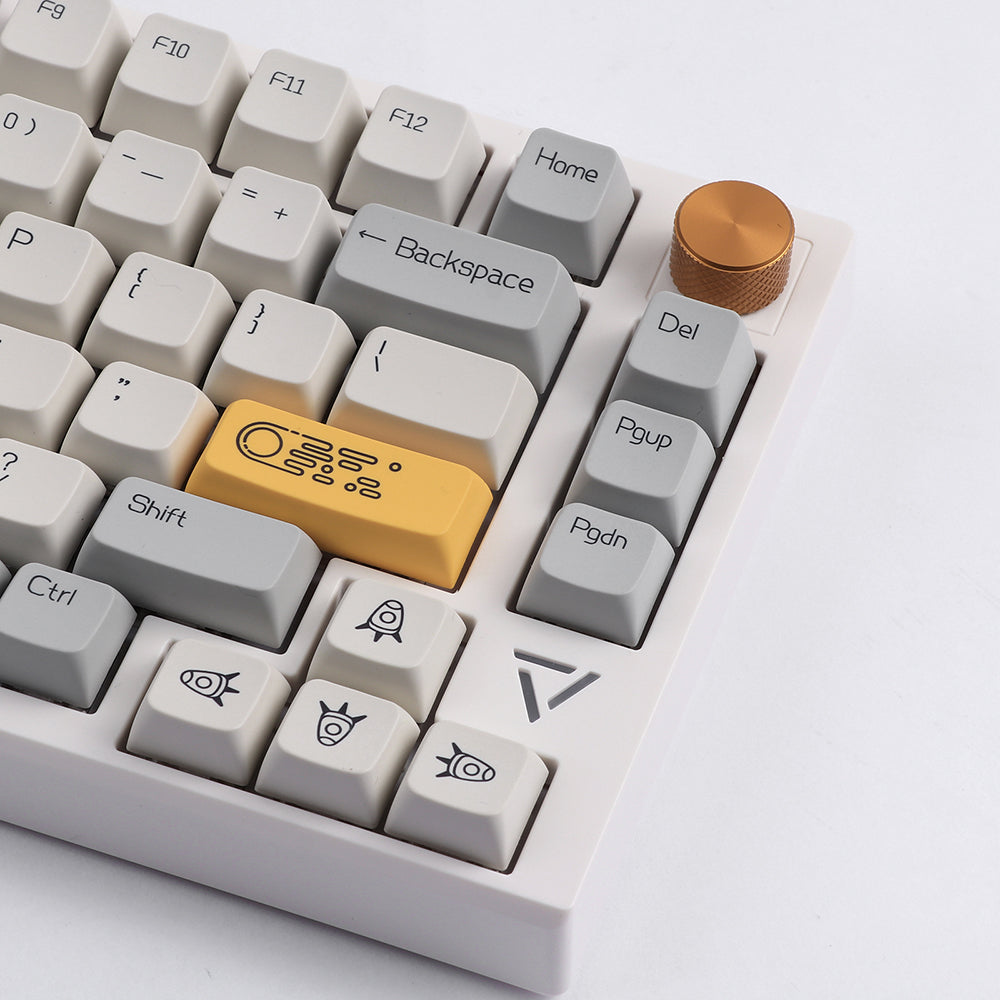 A close-up image of the Ajazz AK816 Pro mechanical keyboard, showcasing the unique keycaps, gold-colored volume knob, and compact 75% layout.