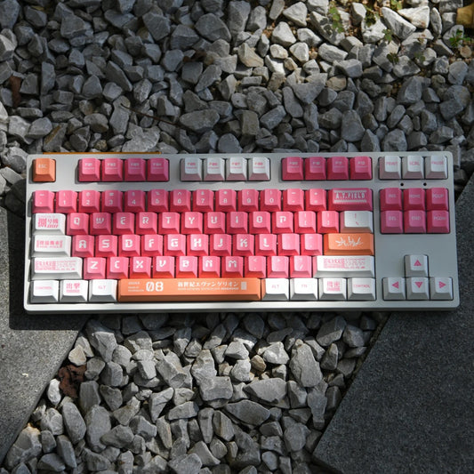 A mechanical keyboard with pink and white keycaps featuring the Evangelion Unit 08 logo and other anime-inspired designs.